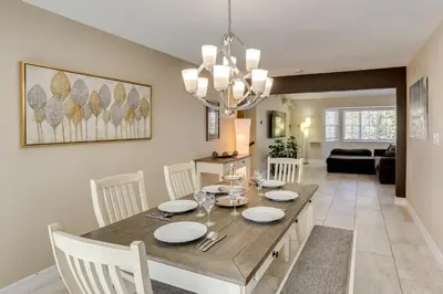 a dining room and living room with a table and chairs at Gateway to Mt Rose Ski! Reno Home Near Casinos in Reno