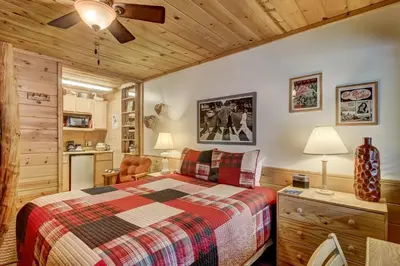 a bedroom with a bed and a kitchen at Heavenly Valley Lodge in South Lake Tahoe