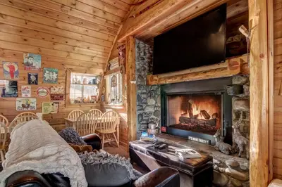 a living room with a fireplace and a tv at Heavenly Valley Lodge in South Lake Tahoe