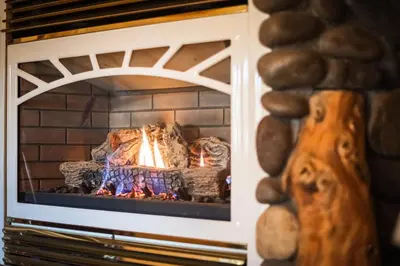 a brick fireplace with a fire in it at Heavenly Valley Lodge in South Lake Tahoe