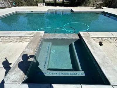 a swimming pool with a hose in the water at Adorable One Bedroom Cottage in Oakdale