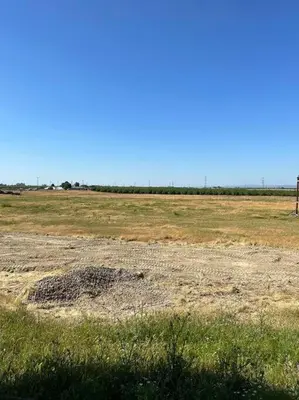 a field with a large pile of dirt in a field at Adorable One Bedroom Cottage in Oakdale