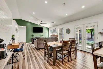 a dining room and living room with a table and chairs at Magnolia Peaceful Vibes Cozy Near Hospital in Hanford