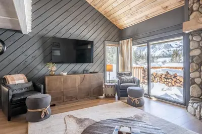 a living room with a wood paneled wall at Snowcreek II 2 plus loft 2 bathroom end unit condo sleeping 8 people with amazing mountain view in Mammoth Lakes