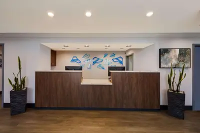 an office lobby with a reception desk with blueprints on the wall at Best Western Inn & Suites Lemoore in Lemoore