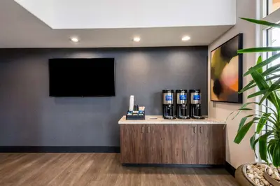 a waiting area with a flat screen tv on a wall at Best Western Inn & Suites Lemoore in Lemoore