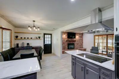 an open kitchen and living room with a fireplace at The Cedar Tree in Fresno