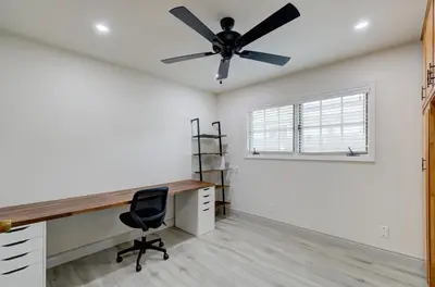 an office with a ceiling fan and a desk at The Cedar Tree in Fresno