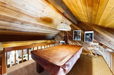 a large wooden table in a room with wooden ceilings at Snowcreek 234 in Mammoth Lakes