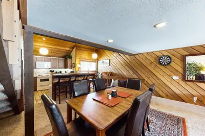 a dining room and kitchen with a table and chairs at Snowcreek 234 in Mammoth Lakes