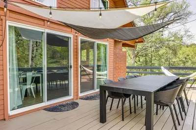 a wooden deck with a table and chairs on a house at Groveland Vacation Rental about 24 Mi to Yosemite! in Groveland