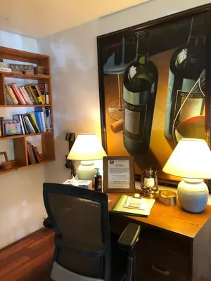 a desk with a chair and a bottle of wine on it at Tahoe Cottage perfect for couples and outdoor enthusiasts in South Lake Tahoe