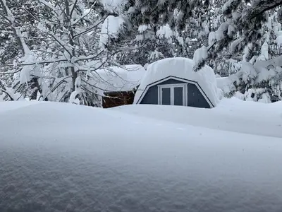 a tent covered in snow in front of trees at Tahoe Cottage perfect for couples and outdoor enthusiasts in South Lake Tahoe