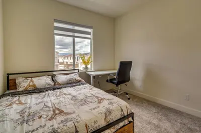 a bedroom with a bed and a desk and a window at California Midterm Rental with Fenced Yard! in Tracy