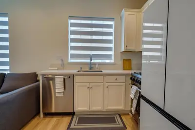 a kitchen with a sink and a refrigerator at California Midterm Rental with Fenced Yard! in Tracy