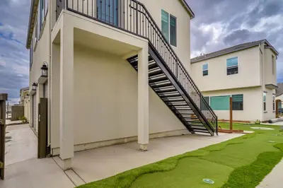a staircase leading up to a house with a yard at California Midterm Rental with Fenced Yard! in Tracy