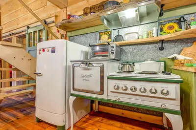 a kitchen with a stove and a refrigerator at Creekside Cabin about 20 Mi to Kings Canyon Park! in Badger