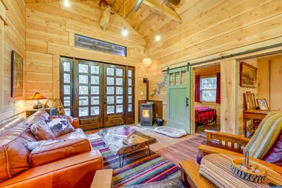 a living room with a couch and a table at Creekside Cabin about 20 Mi to Kings Canyon Park! in Badger