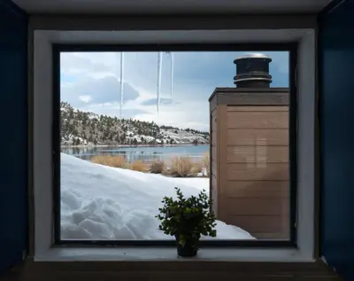 a window with a potted plant in the snow at Rr-edgewater06 in June Lake
