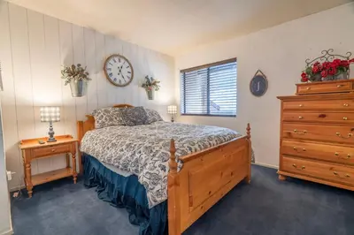 a bedroom with a bed and a clock on the wall at Rr-edgewater06 in June Lake