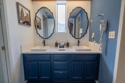 a bathroom with two sinks and two mirrors at Rr-edgewater06 in June Lake