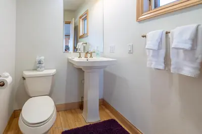 a white bathroom with a toilet and a sink at Rr-johnson Suite 2 in June Lake