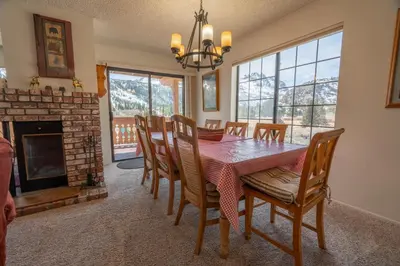 a dining room with a table and chairs and a fireplace at Rr-interlaken 25 in June Lake