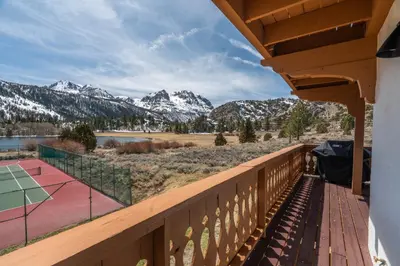 a balcony with a tennis court and mountains at Rr-interlaken 25 in June Lake