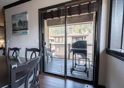 a dining room with a sliding glass door to a balcony at Rr-edgewater16 in June Lake