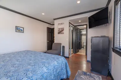 a bedroom with a bed and a flat screen tv at Rr-edgewater16 in June Lake