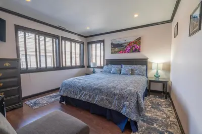 a bedroom with a bed in a room with windows at Rr-edgewater16 in June Lake