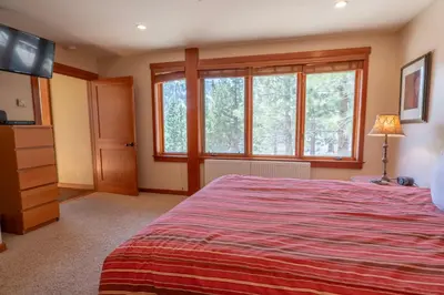 a bedroom with a large bed and a television at Rr-interlaken 17 in June Lake