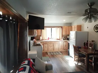 a kitchen with a couch and a table and a refrigerator at Rr-gull Lake Baby House in June Lake