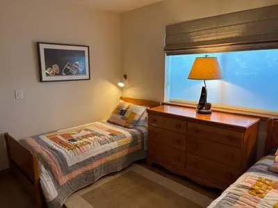 a bedroom with two beds and a lamp on a dresser at Rr-edgewater09 in June Lake