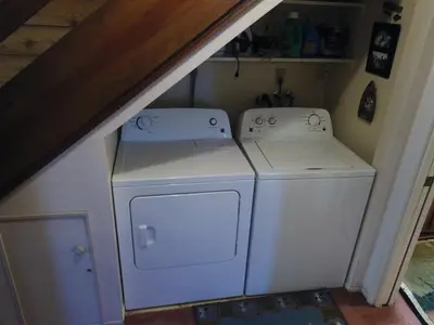 a laundry room with a washer and dryer under a staircase at Rr-edgewater09 in June Lake