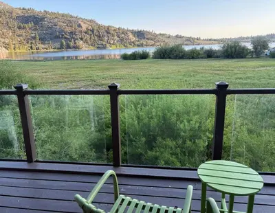 a deck with two chairs and a view of a field at Rr-edgewater09 in June Lake
