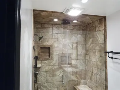 a bathroom with a shower with a stone wall at Rr-edgewater20 in June Lake
