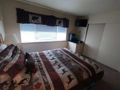 a bedroom with a bed with a comforter and a window at Rr-edgewater13 in June Lake