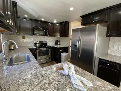 a kitchen with a granite counter top and stainless steel appliances at Rr-edgewater17 in June Lake
