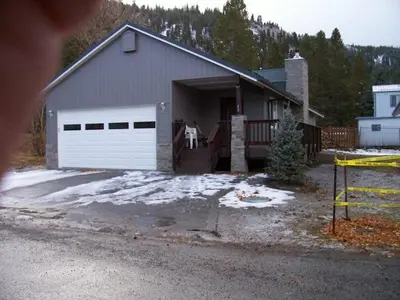 a house with a garage with snow on the driveway at Elk House in June Lake