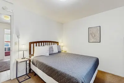 a bedroom with a bed and a table with a lamp at Saddle Road Sanctuary in South Lake Tahoe