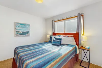 a bedroom with a bed and a window at Saddle Road Sanctuary in South Lake Tahoe