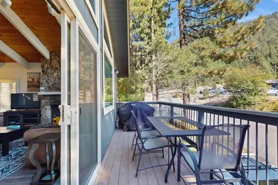 a patio with a table and chairs on a balcony at Saddle Road Sanctuary in South Lake Tahoe