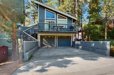 a large house with a balcony and a garage at Saddle Road Sanctuary in South Lake Tahoe
