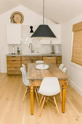 a kitchen with a wooden table and white chairs at Casita- Lake Area Winter Special Ends 51626 in Bass Lake