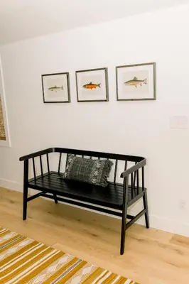 a black bench in front of a white wall at Casita- Lake Area Winter Special Ends 51626 in Bass Lake