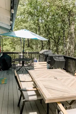 a table and chairs with an umbrella on a deck at Moreno-Lake Area Free Night Special in Bass Lake