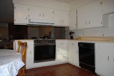 a kitchen with white cabinets and a black oven at Cedar-Lake Area Winter Special Ends 51626 in Bass Lake