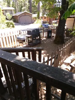 a wooden bench in a yard with a fence at Cedar-Lake Area Winter Special Ends 51626 in Bass Lake