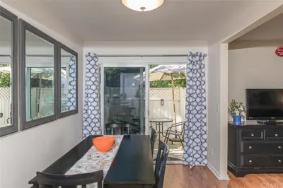 a dining room with a table and chairs and a television at Rosenberg Slide Creek Reduced Nightly Rate in Bass Lake